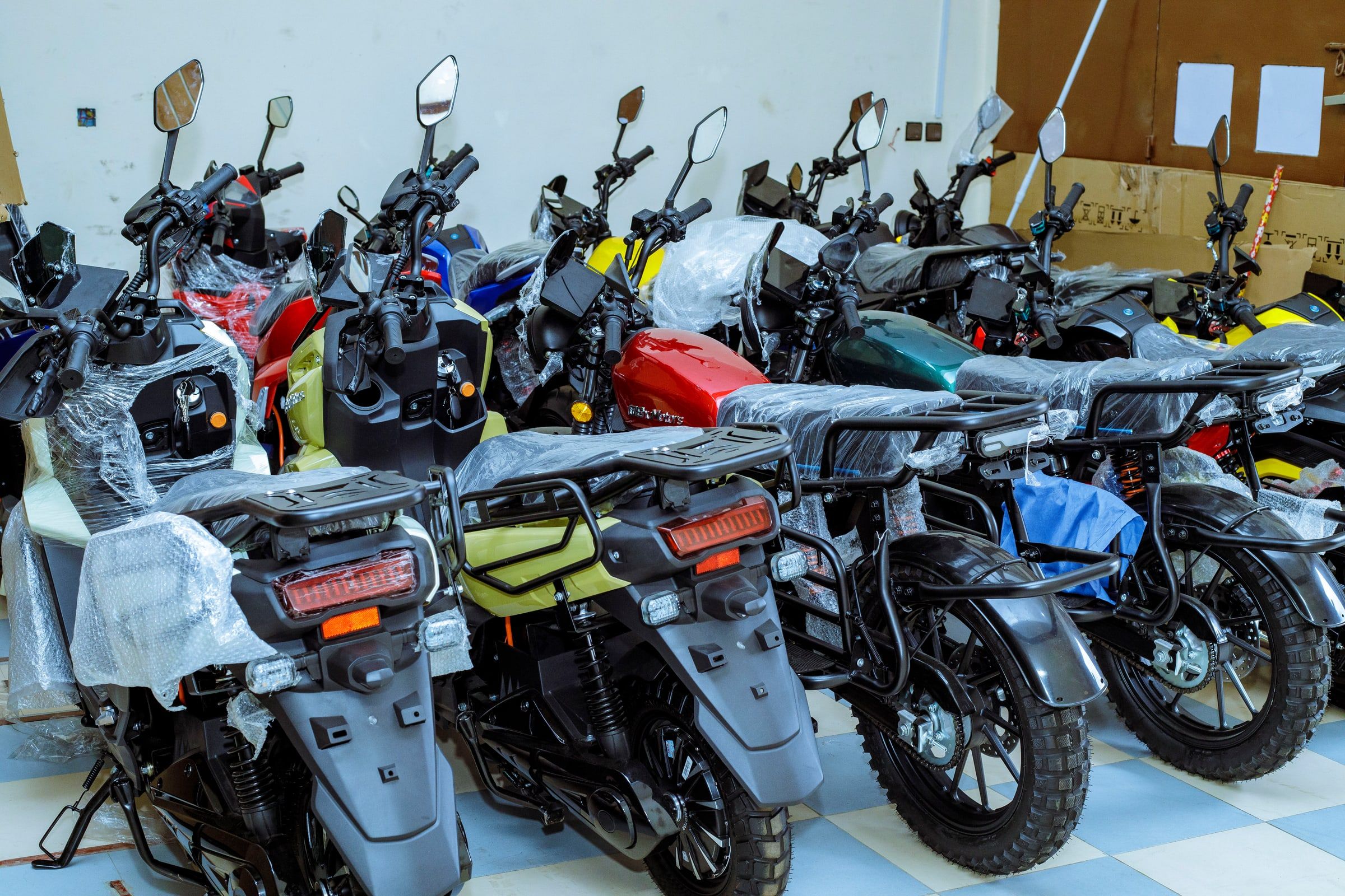 A row of new Ehu electric motorcycles, ready for delivery.