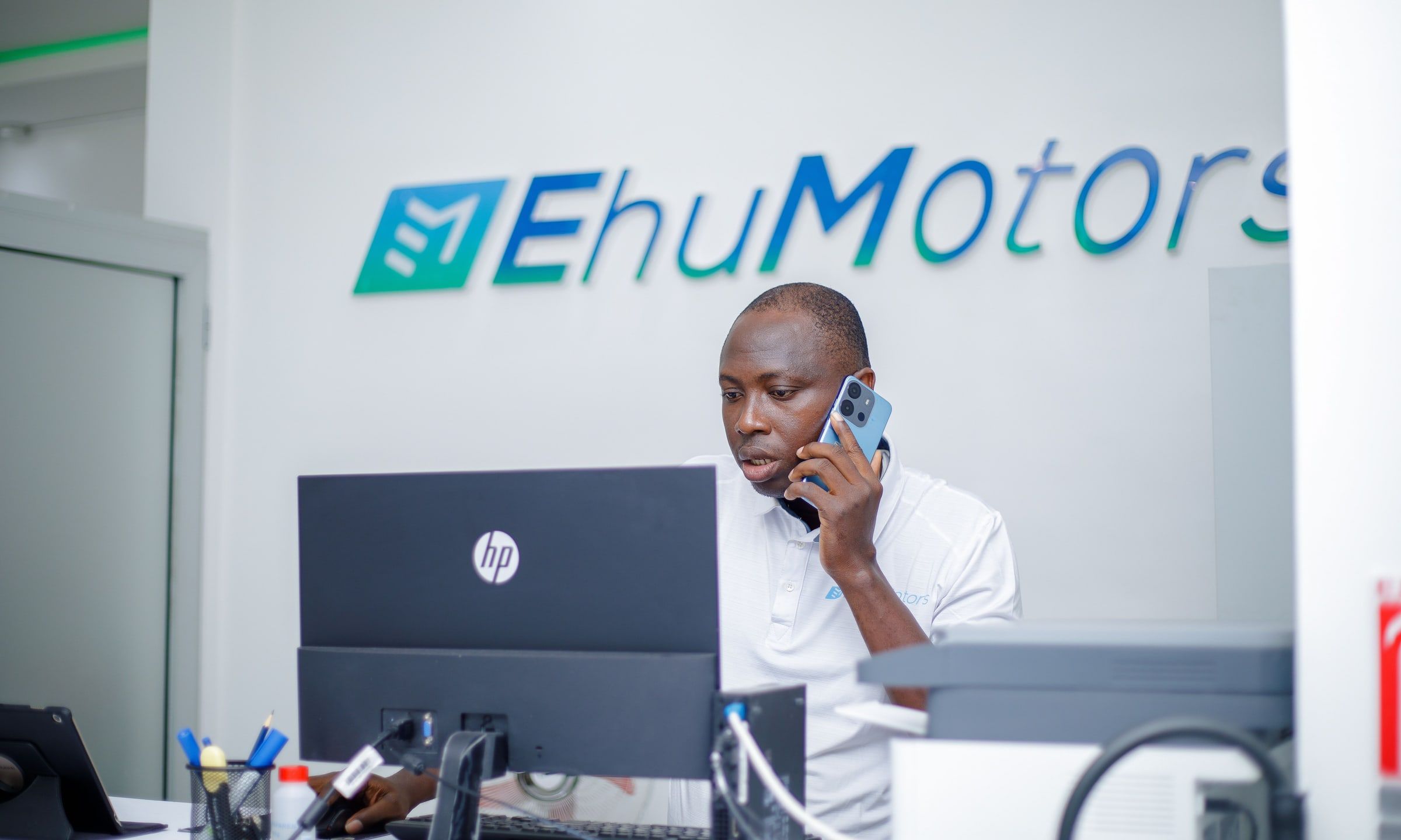 The reception of the Ehu Motors showroom in Cotonou, with the brand logo on the wall.