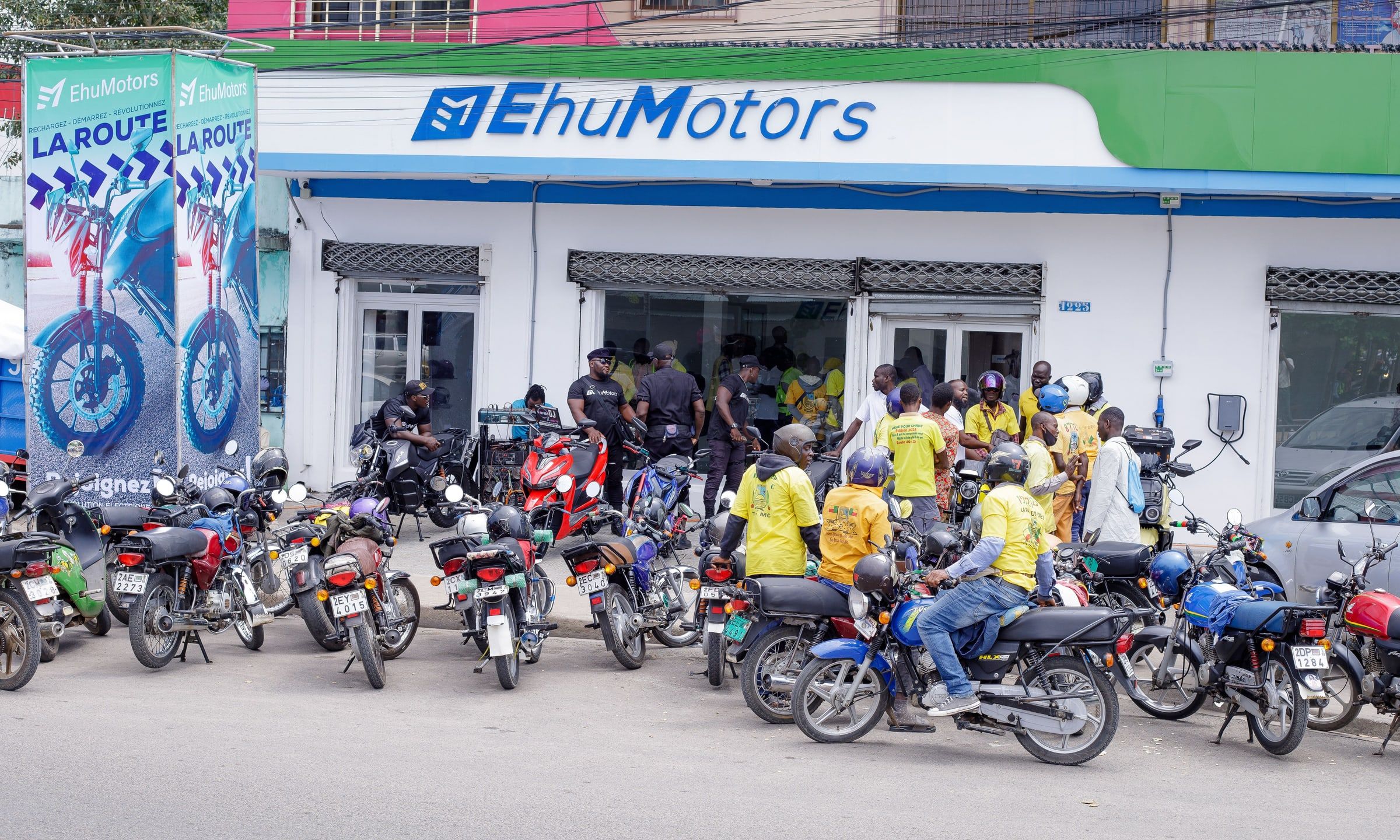 The front of the Ehu Motors showroom in Cotonou, with dozens of riders outside.